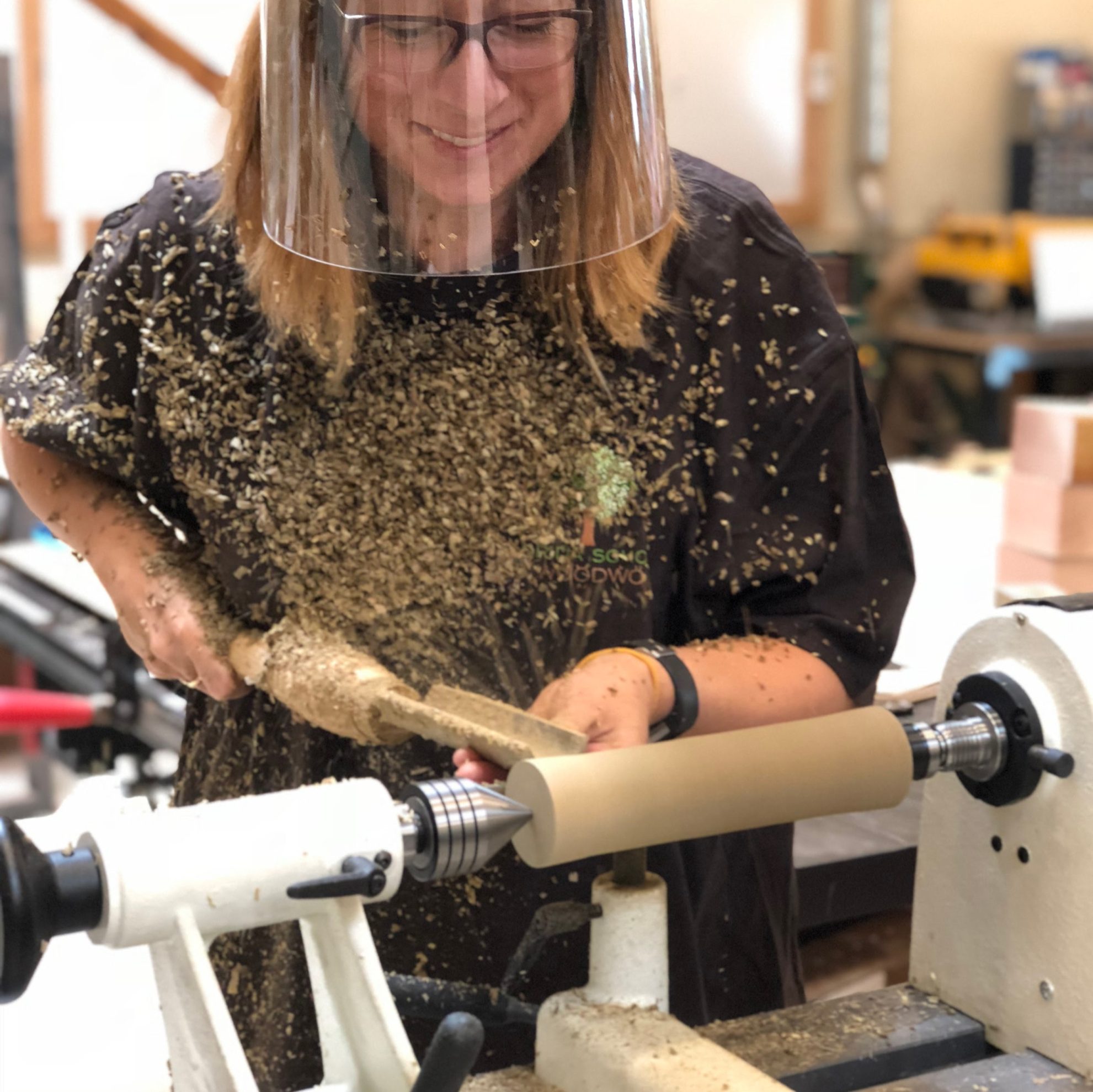 female student learning to turn wood